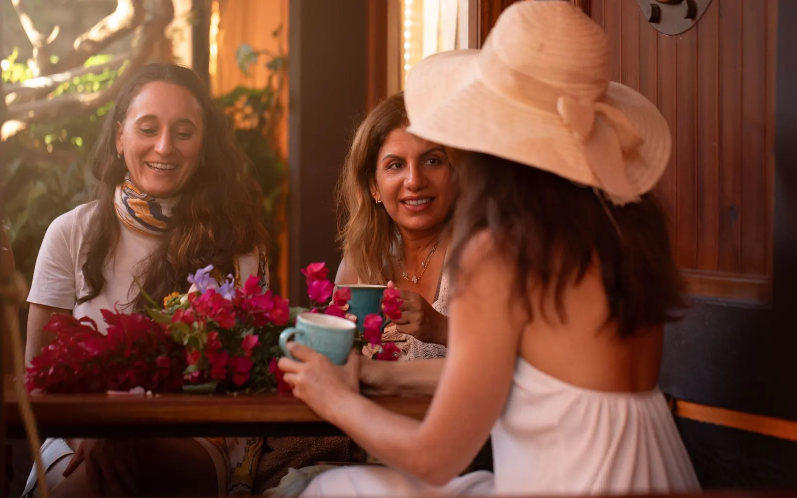 Shared meal at a table with flowers in the retreat quinta above Funchal